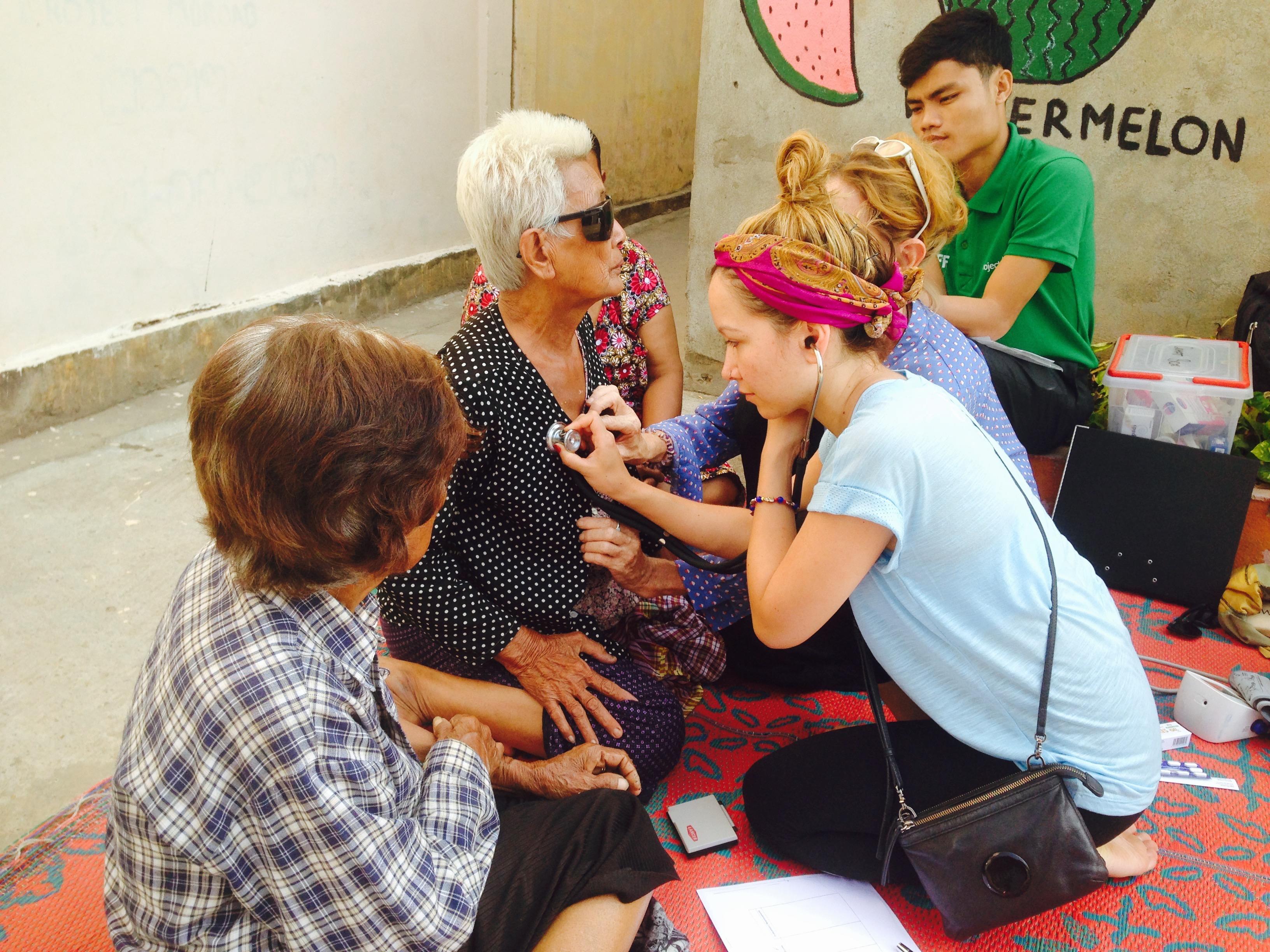 Students learn how to check vital signs during a Projects Abroad outreach on the Public Health Internship for teenagers in Cambodia. Interns learn how to check the vital signs of a patient as part of Public Health work for teenagers in Cambodia.
